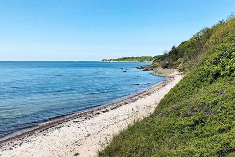 One of Bornholm's best located holiday homes with whirlpool. Beach plot directly next to the Baltic Sea and with a fine sandy beach below the cottage. The large wooden terrace, which surrounds the two sides of the cottage, is built over the slope. Gr...