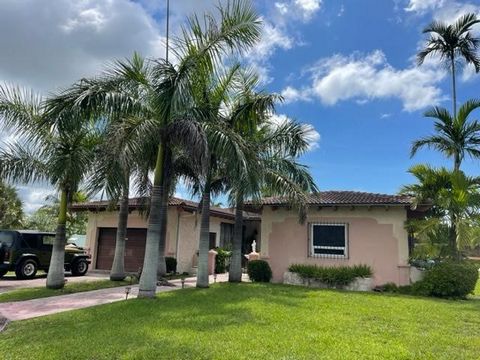 This unique Spanish style home with a pool, 2 car garage and a backup generator are a rare find. The property is laden with fruit baring trees and backs onto what used to be a golf course and will be again. Entrance to the property with a circular dr...