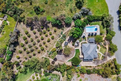 Welcome to your own secluded sanctuary surrounded by natural beauty in the community of Hacienda Santa Fe. Beyond the gated entry, discover a breathtaking estate ensconced with a lush orchard, offering unparalleled privacy and tranquility. This remod...