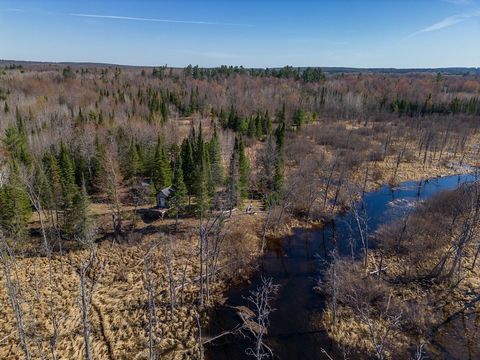 This 182 +/- acre pristine river property with 3000+ feet of frontage on the South Branch of the Au Sable River features a log cabin with a majestic white pine setting to a main trail to the elevated outpost cabin overlooking the river.The trail syst...