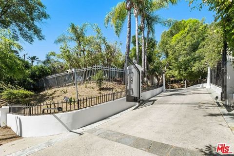 Nestled atop a private driveway on of the best streets in Tarzana, this gated private estate offers views, sprawling grounds and lush landscapes to provide seclusion and great modern living. This single-family home boasts approximately 3,436 square f...