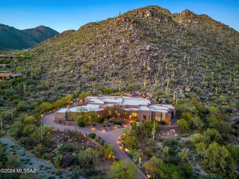 Located in exclusive Canyon Pass in Dove Mountain, this captivating desert contemporary home sprawls over 1.8 acres of stunning landscape and mountain views. Boasting an expansive dream kitchen with Viking appliances, wet bar, and temperature control...
