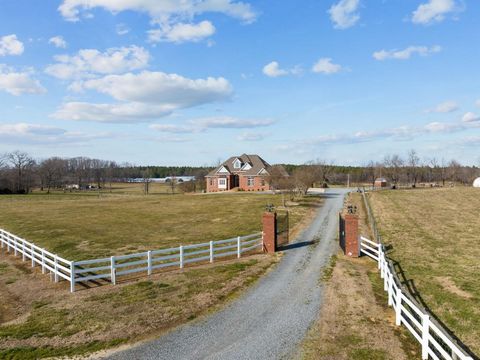 Step into a world of luxury in the heart of farm country! This custom-built masterpiece, erected in 2004 on 13.3 acres, offers nearly 6000 sqft of elegance. The property is a secured haven with a remote-controlled gate, a 50X150 building, and a fence...