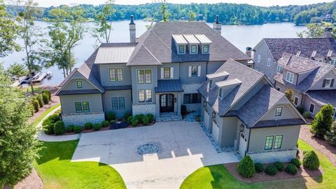 EXCEPTIONAL LAKEFRONT RESIDENCE WITH BREATHTAKING VIEWS FROM VIRTUALLY EVERY ROOM, FEATURING EXPANSIVE PORCHES, A POOL, AND AN ELEVATOR. Crafted by DreamBuilt in 2018, no expense was spared in creating this unique masterpiece. The open floor plan boa...