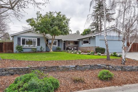 Exuding timeless ranch style, this meticulously updated home features a bright, open design complemented by the beautiful hardwood and tiled floors. The central gourmet kitchen seamlessly connects to the living and dining areas, while sliding glass d...