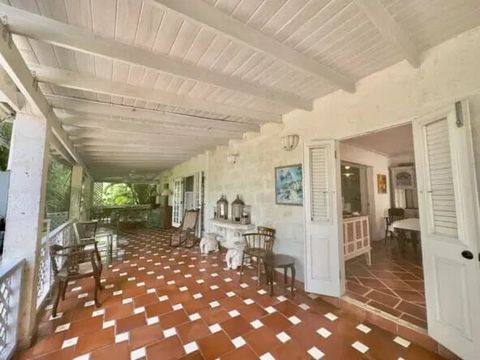 This charming coral stone home is nestled in a peaceful cul de sac, surrounded by lush gardens. With three bedrooms and three bathrooms, this property offers ample space and comfort. Positioned on a hill, the home takes full advantage of refreshing b...