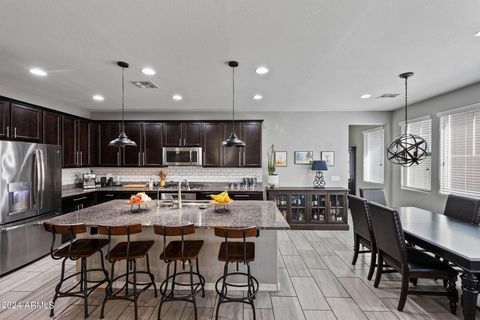 Introducing this stunning on-trend home in the peaceful Bungalows at Cooley Stations neighborhood. The eat-in chef's kitchen boasts granite counters, stainless steel appliances, a gas cooktop, expansive island with breakfast bar, and a stylish subway...