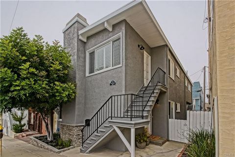 Nestled in Hermosa Beach’s coveted Sand Section, just a block from the ocean, this stunning duplex is more than just a place to live—it’s a front-row ticket to the beach lifestyle. The top unit is a true showstopper, seamlessly blending modern update...