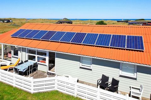 This is a bright and spacious holiday cottage on a large natural plot, close to a family friendly beach and with a view of sand dunes. The solar cells provide clean energy. Enjoy the sunroom with its view of the dunes. There is also a fenced-in terra...