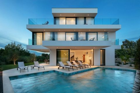 A luxury villa with a swimming pool and an elevator is for sale in Sukosan. Find your corner of paradise by the coast of the Adriatic Sea in this modern luxury villa located in the second row to the sea. Only a few meters from the coast, this villa o...