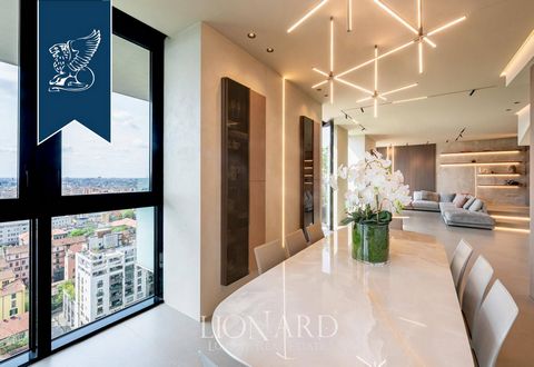 In Milan's thriving financial district, near Piazza Gae Aulenti, this lavish two-story penthouse is for sale. Situated on the 13th floor of a prestigious building with elevator access, this 316-sqm estate boasts three spacious bedrooms, five bat...