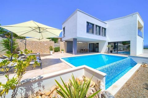 Bright newly built furnished villa in Krk town area of exceptional modern design! Surface area 223 m2 for sale, with swimming pool, landscaped garden and partial sea view, on a plot of 591 m2. The villa consists of three levels. Basement offers welln...