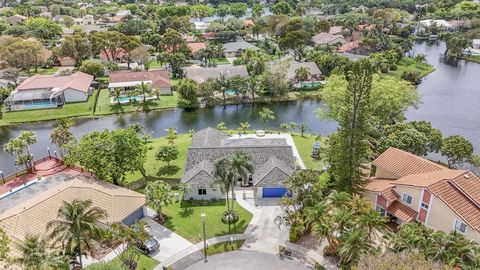 Welcome to your dream home in highly sought-after Jacaranda Lakes. This renovated, exquisite and modern 4BR, 2.5BA, 2 car garage home is situated on the largest lot (14k+ sq ft!), boasting an expansive backyard stretching 175 feet along the lakefront...
