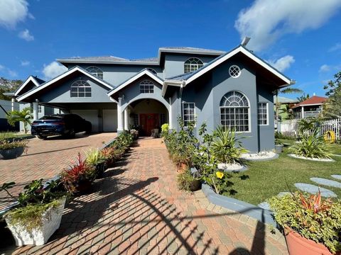 Nestled within a gated oasis with manned security, this beautiful 5-bedroom home offers the perfect blend of privacy and camaraderie. Entertain your loved ones by the complex's lake - fishing on sunny, family fun days - creating cherished memories th...