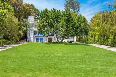 This exquisite storybook home is situated atop a picturesque hill in the delightful Old Agoura. This extraordinary Cape Cod-style residence boasts mesmerizing mountain views, horse stables, and an array of upgrades, including a custom pool/spa, lands...
