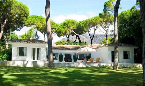 A FABULOUS FRONT-LINE BEACH VILLA with spectacular sea and mountain views, located on Marbella's Golden Mile close to Marbella Club hotel area. This pleasant, Spanish style property consists of four en-suite bedrooms, a spacious living/dining area an...