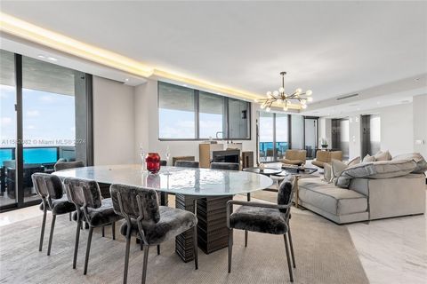 Welcome to the prestigious Porsche Design Tower, where luxury & innovation converge. This upgraded & rarely available larger 05 residence offers 4 bedrooms + maids, 4.5 baths, & media room spanning 3,555 SF w/ a private garage. Chef's kitchen feature...