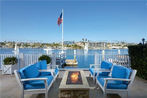 The pinnacle of Newport Beach living awaits at this picture-perfect bayfront home on the southern tip of the Balboa Peninsula. Offering 53' of frontage on the water and a private dock that can accommodate a vessel up to 45', this luxurious New Englan...