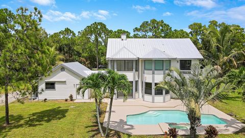 Experience the best of what Jupiter Farms has to offer in this newly renovated 3 bedroom, 3 bathroom Pool home featuring a separate 1600 sq ft (40X40) Air Conditioned Garage Workshop! This home has NEW FLOORING, NEW IMPACT WINDOWS, NEW METAL ROOF, NE...