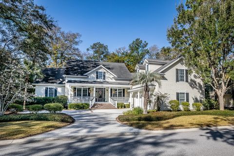 Charming Lowcountry Home is Designed for Comfort and Livability! Careful attention to every detail is apparent from the welcoming front porch, tabby driveway and walks leading to golf cart garage to the custom detailing on interior trim with larger c...