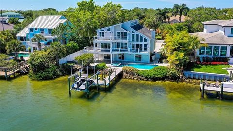 Where Phillippi Creek meets the Intracoastal, there you'll find 5422 Siesta Cove Drive, home to 3 stories of pristine water views and some of the best dolphin and bird watching you'll find on the Key! Renovated from top to bottom and complete with an...