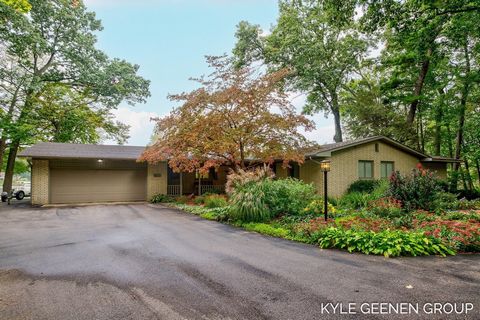 Welcome to your dream lakeside retreat with 134 ft of private frontage on Lake Macatawa! As you approach the property, a charming stone pathway leads you through meticulously landscaped gardens, bursting with vibrant blooms and fragrant blossoms. Ste...