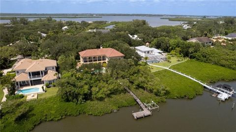 Sited on 125 +/- of luxe water-frontage, the stunning architectural design of this custom build, multi-level estate, is framed by old growth live oak trees, windowed mangroves and lush, tropical privacy landscape. Featuring four bedrooms, 4.1 bathroo...