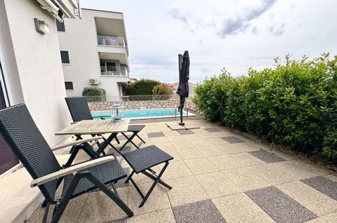 The island of Krk, town Krk, furnished apartment surface area 63,84 m2 for sale, on the ground floor of an apartment building, with pool and landscaped garden of 74 m2. The apartment consists of living room, kitchen, dining area, two bedrooms, bathro...
