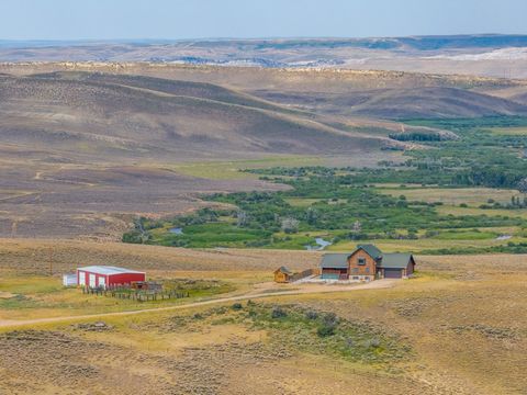 Located just minutes outside Kemmerer, Wyoming, this meticulously crafted log home epitomizes rustic luxury, commanding breathtaking views of the Hams Fork River and the majestic Uinta Mountains. Set on 92 acres of pristine land, the property is a ha...