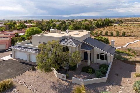 This absolutely stunning North Albuquerque Acres property sits on a .89 acre lot with gorgeous views of the Sandia Mountains above and the Western Valley below. Saltillo tile welcomes you as you enter this spacious and meticulously cared for home. Th...