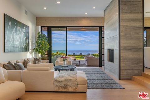 Welcome to your coastal paradise situated in a prime location on Malibu's famed Broad Beach. Beyond the entry and down a tranquil stone pathway lies a significant architectural compound, a haven of sophistication and tranquility surrounded by lush la...