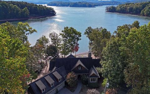 Lakefront home on gentle point lot with deep water & long-range mountain views. Main Level offers ensuite, living room, dining room, kitchen, office with half bath, laundry room, walk-in closets, large screened porch, open deck area & 3-car garage. T...