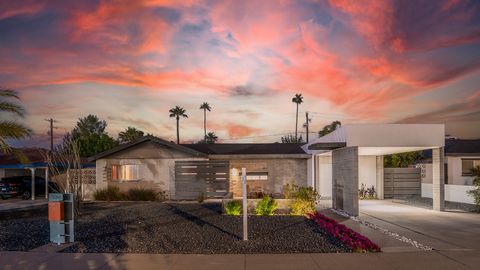 Your mid-century retreat in Arcadia awaits. Over 27 varietals of fruit trees create an atmosphere that is lush and private with Camelback Mountain views. New ceramic tile floors expand this 4 bed, 2 bath open concept home creating a bright and spacio...