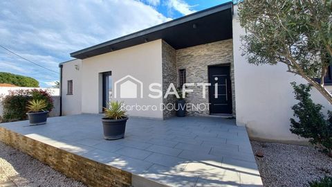 Belle villa de plain pied avec terrasses, jardin et garage.