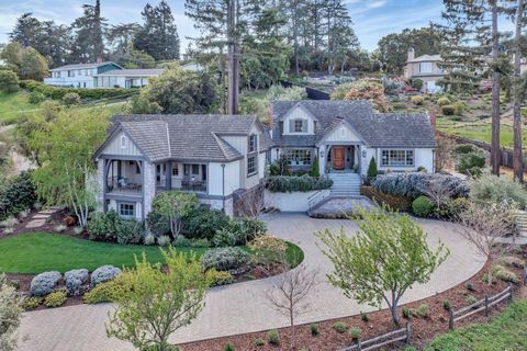 Just a mile from the Los Altos Village, this stately Country Manor on over an acre has views out to the San Francisco Bay and East Bay hills. A long paver stone driveway surrounded with lush foliage leads up to a dramatic split front staircase. Class...