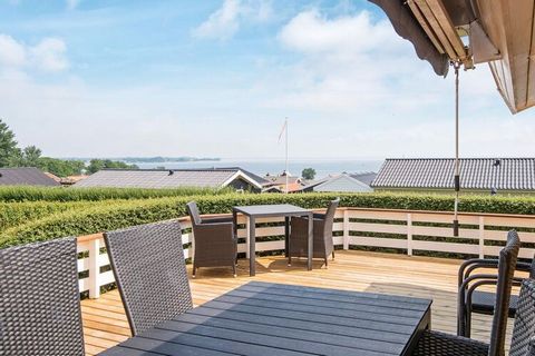 Elevated holiday cottage with sauna and panoramic views of Little Belt, Binderup Bugt and across to Funen. The furnishings is bright and modern. There are several terraces of which is covered and one has an awning and furthermore there is a heater fo...