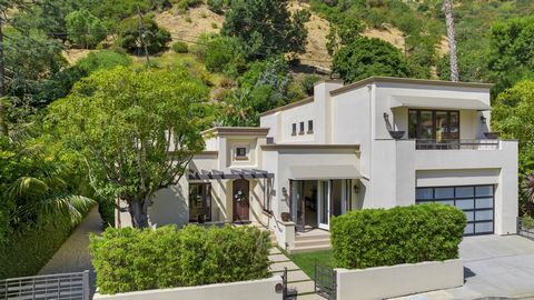 Welcome to 1607 N Beverly Dr, an elegant contemporary Mediterranean residence boasting a gracious oversized lot with verdant yard spaces and gardens. Although ideally situated just minutes from Beverly Hills' world-class shopping and dining, the prop...