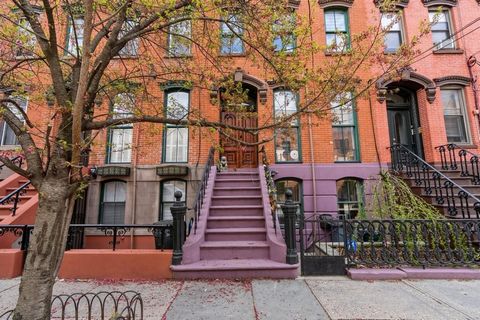 Tucked away on a tranquil, tree-lined street in the heart of downtown Jersey City, this elegant and expansive townhome offers a rare blend of classic charm and modern luxury. Spanning five beautifully curated levels, this legal two-family residence c...