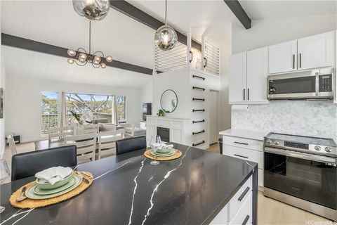 Welcome Home! This renovated split-level townhome offers a delightful fusion of contemporary comfort and captivating ocean view! As you enter, the spacious and luminous living area welcomes you with its vaulted ceiling and inviting electric fireplace...