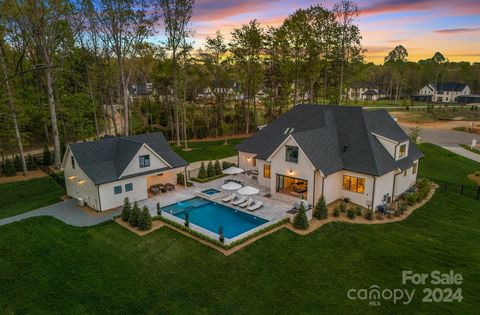 Nestled along the pristine shores of Lake Norman, this exquisite 2022 waterfront estate redefines the concept of resort style living. Welcome to your private oasis sprawling across 1.49 acres w/ over 180' of shoreline, deeded dock w/lift, sandy beach...