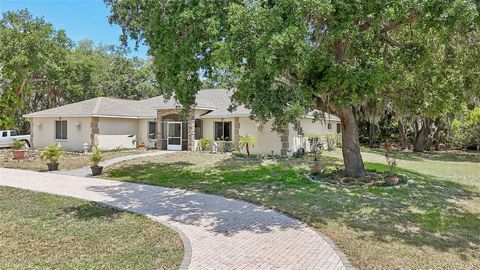 Rare opportunity to BUY your dream home on a private one acre lot in Sarasota. This spacious custom home offers four bedrooms, 2 bathrooms plus a den. Upon entering thru the front door you are greeted with a grand entrance of columns, marble veined t...