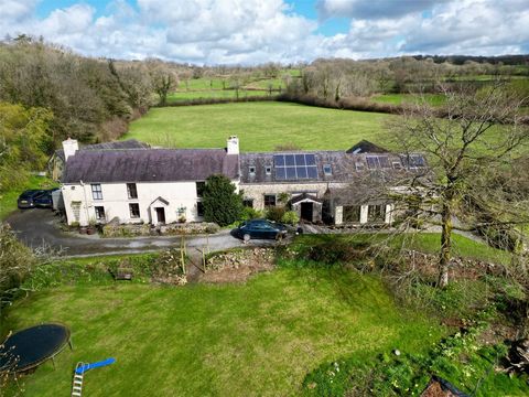 Nestled in a peaceful setting, this substantial six-bedroom family home sits at the heart of over 20 acres of land, offering versatile accommodation with potential for a small annex in one wing. The grounds boast a delightful mix of pasture, wooded c...