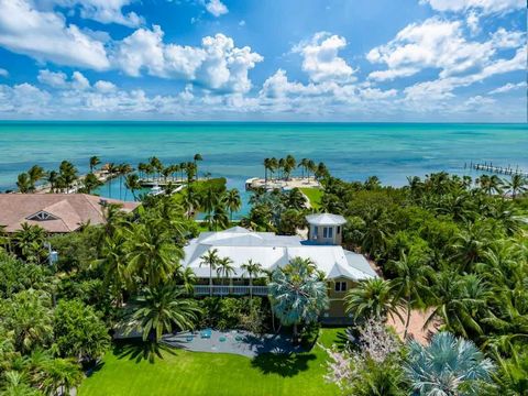 Nestled within exclusive Sugarloaf Beach, on a gated, abundantly private 2.5-Acre lot, lies an incomparable, 5,200 Sq. Ft. Oceanfront Estate, boasting unparalleled resort-style amenities! A protected, 6-Boat Basin with 25K and 16K lifts, with boat ra...