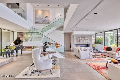$3M price reduction! The most extraordinary Contemporary architectural masterpiece looks Brand New! This dramatic GLASS HOUSE sits high on the mountain across from Paradise Valley Country Club in a guard gated community. Walk outside from the home wi...