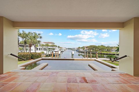 This home is more than meets the eye. Concrete construction with deep pilings for reinforcement. Saltillo terracotta tiles throughout the entire home with the most amazing views down the canal to the harbor and of the gulf with access to the both out...