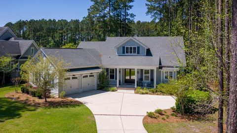 Discover an oasis of tranquility, adjacent to a protected wooded open-space and overlooking a secluded lagoon. Meticulously designed by Southern Coastal Homes, it blends the charm of the Lowcountry with modern convenience, offering an expansive great...