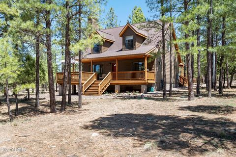 Price Improvement!! Escape to this charming cabin nestled on a lush acre surrounded by towering Ponderosa Pines, fulfilling your dream of mountain living. The exterior has been upgraded with composite siding, giving the home a fresh, modern look. Spe...