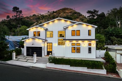 Enjoy serene canyon living surrounded by lush foliage and mountain vistas in this highly desirable pocket of Bel Air. A grand front door gives way to a warm interior filled with natural light from the walls of glass. High ceilings carry throughout th...