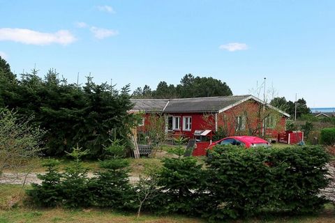 Holiday home located on a secluded plot in a quiet holiday home area within walking distance to the sea at Helberskov. Bright living room with fireplace and heat pump and in open connection with the kitchen and exit to the partially covered terrace. ...