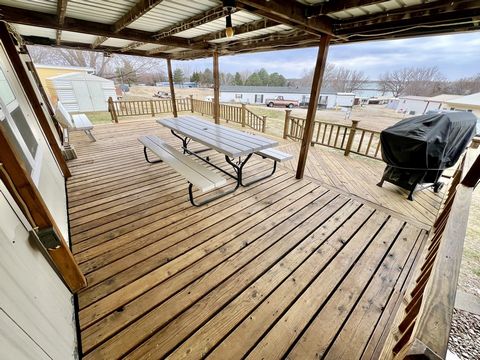 SELLERS MOTIVATED. This cabin at Sherman Reservoir is ready for you to enjoy all summer long in 2024! With views of the water and close proximity to Trade Winds Marina, this furnished 2 bed, 1 bath cabin includes a personal boat slip, carport, entert...
